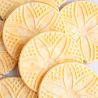 Closeup Shot of Lots of Italian Pizzelle Cookies on White Background