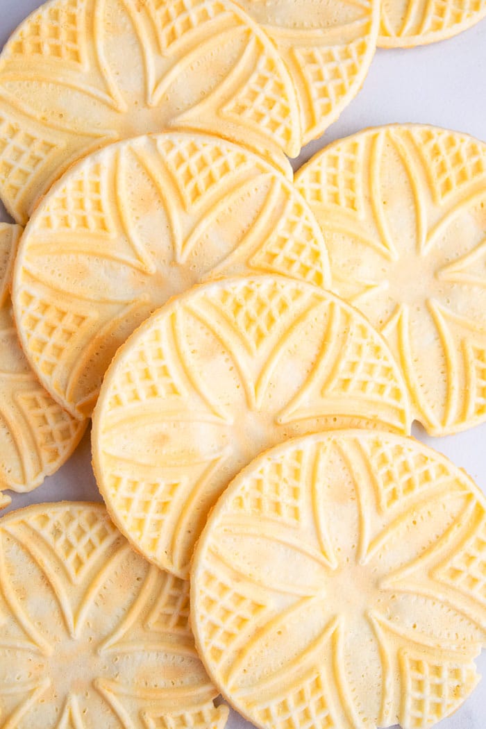 Closeup Shot of Lots of Italian Pizzelle Cookies on White Background