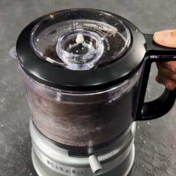 Creamy Oreo mixture being combined in a food processor.  