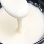 Easy Powdered Sugar Glaze (Vanilla Cake Glaze) in Black Bowl- Closeup Shot