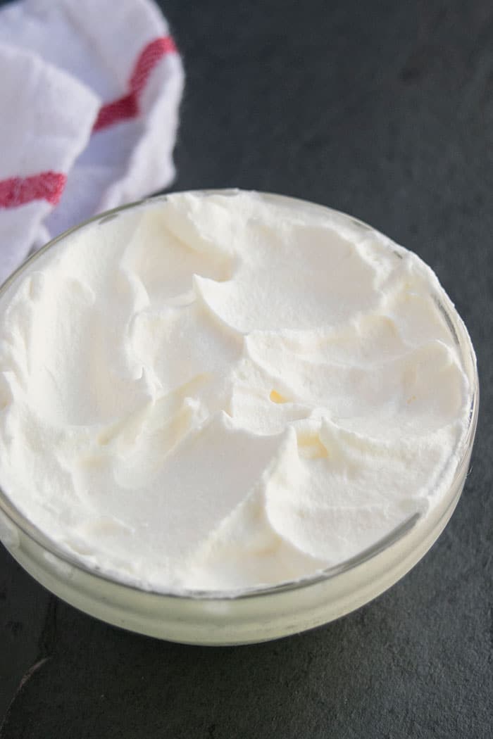 Easy Homemade Chantilly Cream in Glass Bowl on Black Background
