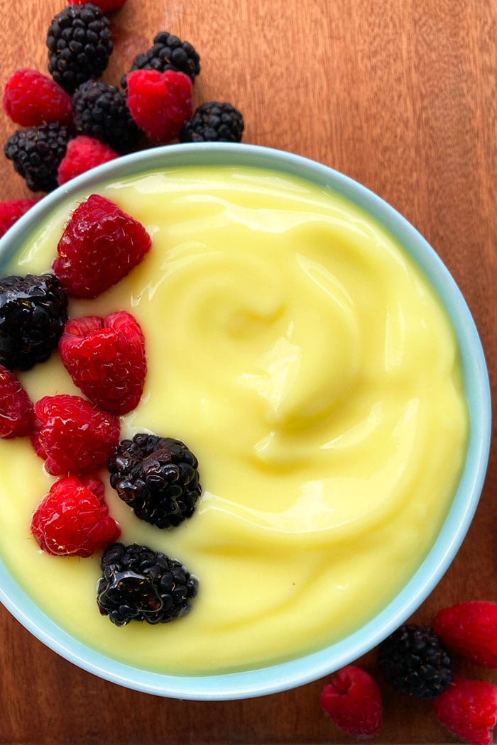 Egg Custard With Fresh Berry Topping in Blue Bowl- Overhead Shot