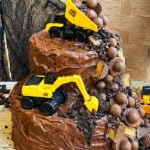 Easy Construction Cake or Excavator Cake With Chocolate Candies on Rustic Background