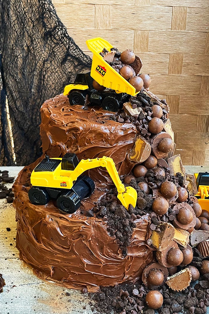 Easy Construction Cake or Excavator Cake With Chocolate Candies on Rustic Background