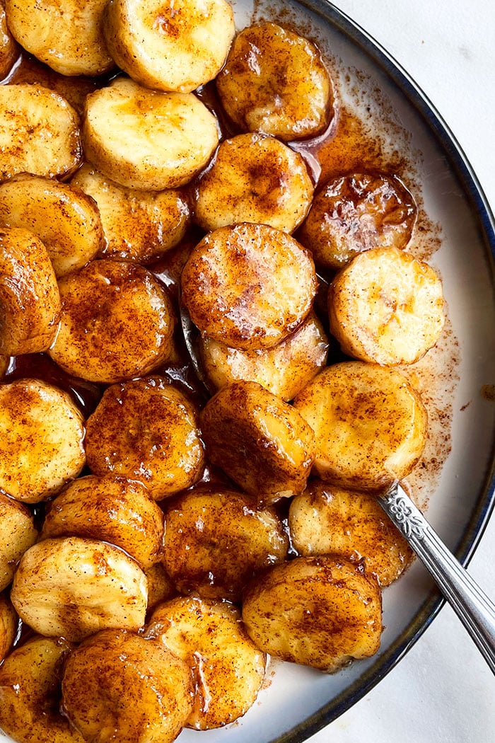 Easy Pan Fried Caramelized Bananas in White Dish With Black Rim- Overhead Shot