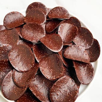 Easy Chocolate Covered Potato Chips in White Plate on White Background