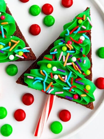 Easy Christmas Tree Brownies With Buttercream Frosting on White Dish.