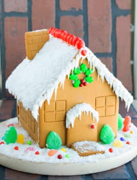 Easy Homemade Gingerbread House on Brick Background