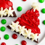 Easy Christmas Santa Hat Brownies With Buttercream Frosting on White Dish.