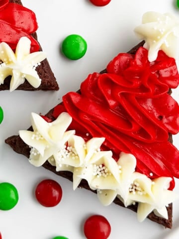 Easy Christmas Santa Hat Brownies With Buttercream Frosting on White Dish.