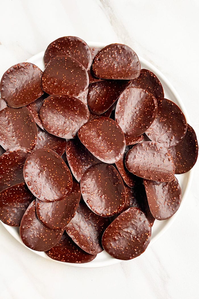 Easy Homemade Chocolate Covered Potato Chips in White Plate on White Background