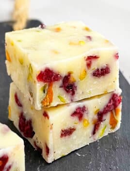 Stack of Easy Sweetened Condensed Milk Fudge With Cranberries, Pistachios on Black Base