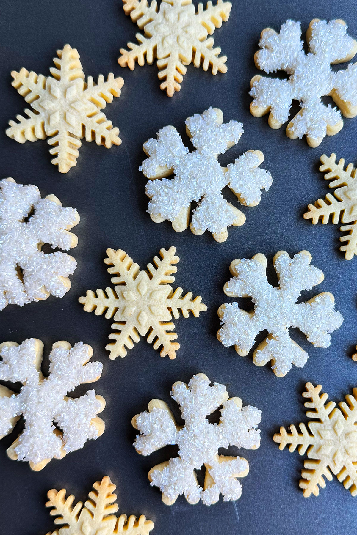 Variety of Easy Cut Out Snowflake Cookies Decorated With Sanding Sugar on Metal Tray. 