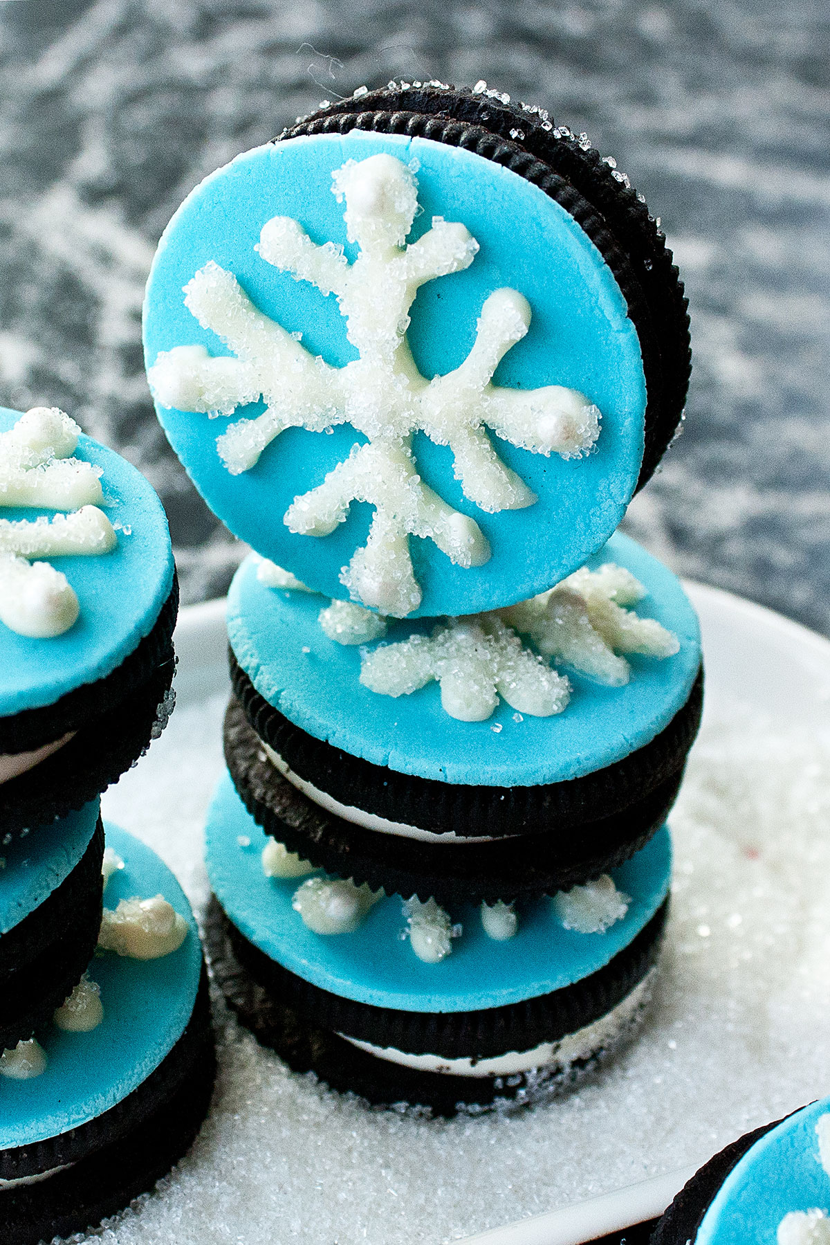 Stack of Easy Fondant Decorated Cookies in White Dish With Sparkling Sugar.