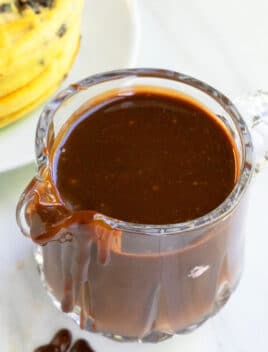 Easy Homemade Hot Fudge Sauce in Glass in Small Glass Pitcher