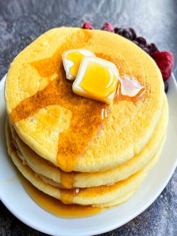 Easy Fluffy Buttermilk Pancakes Stacked in a White Dish