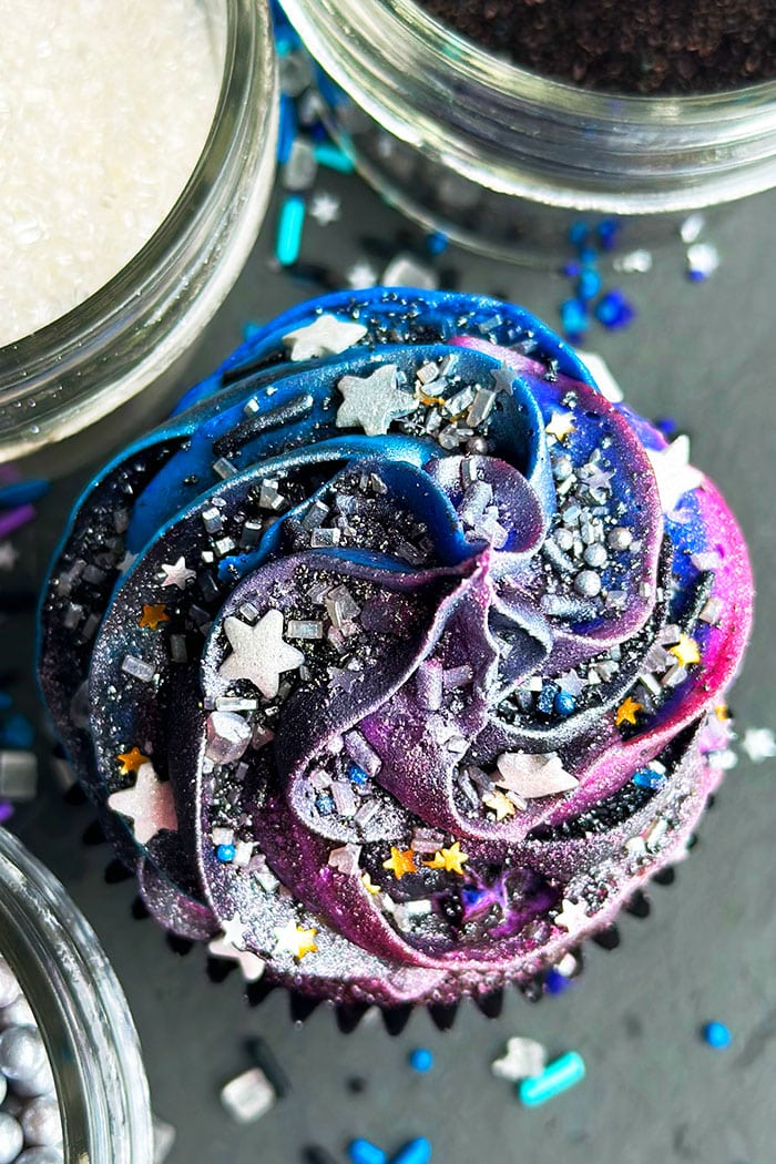 Cosmic Outer Space Cupcakes With Silver Sprinkles on Black Background- Overhead Shot 