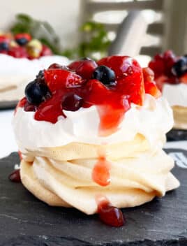 Easy Mini Pavlova With Whipped Cream and Fresh Berries on Black Dish