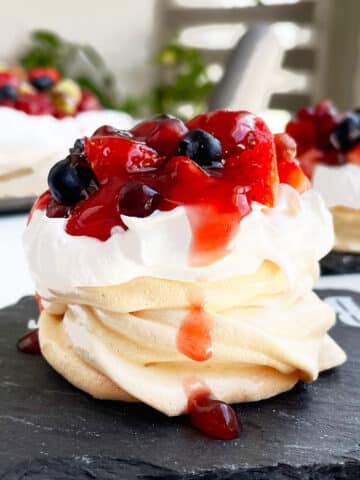 Easy Mini Pavlova With Whipped Cream and Fresh Berries on Black Dish