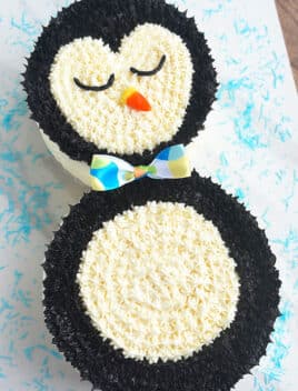 Easy Penguin Cake With Buttercream Icing on White Background With Blue Sprinkles