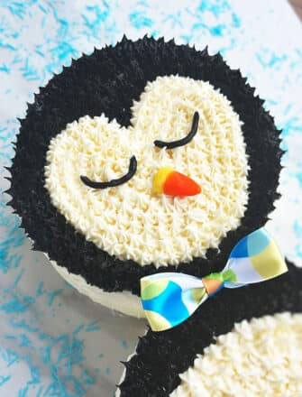 Easy Penguin Cake With Buttercream Icing on White and Blue Background