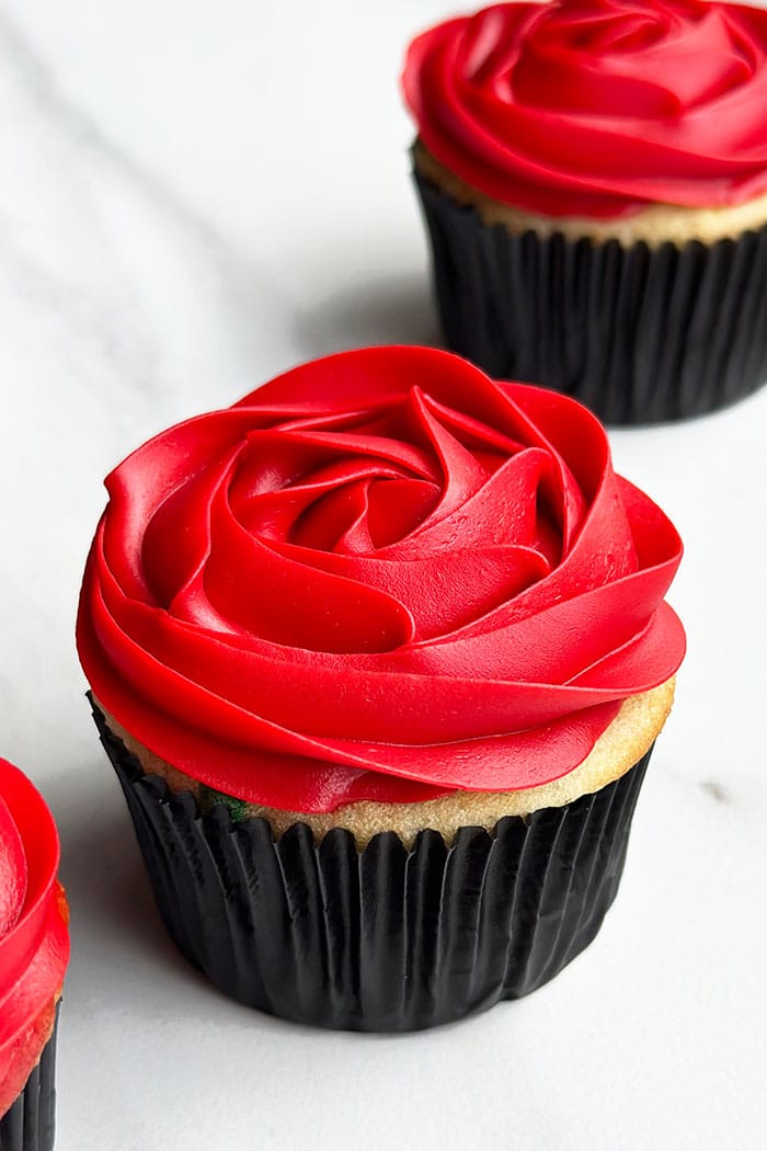 Easy Rose Cupcakes Piped With Red Buttercream Icing on White Background  