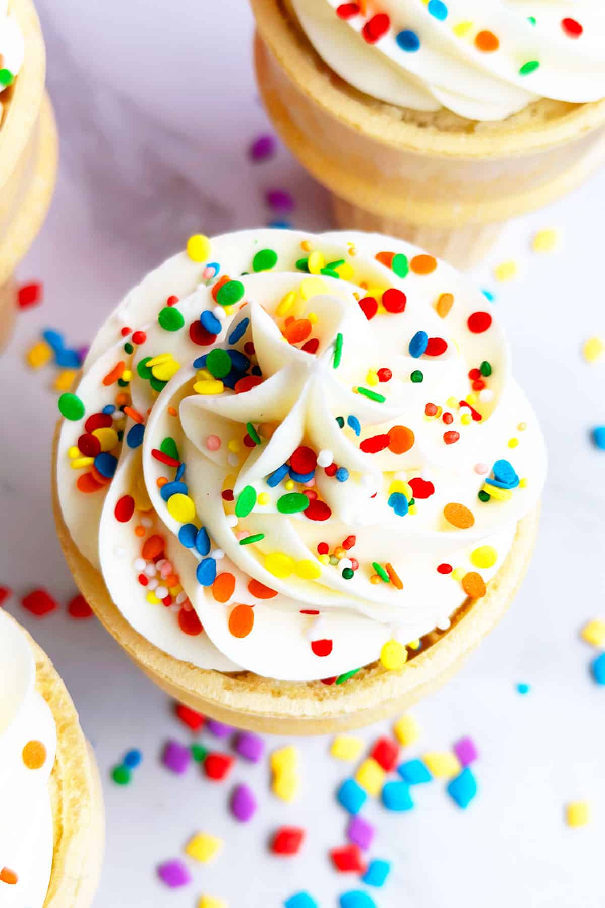 Closeup Shot of Swirl of White Buttercream Icing With Sprinkles