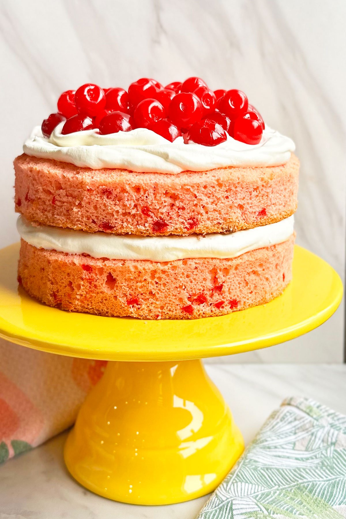 Easy Maraschino Cherry Cake With Cake Mix on Yellow Cake Stand And Marble Background