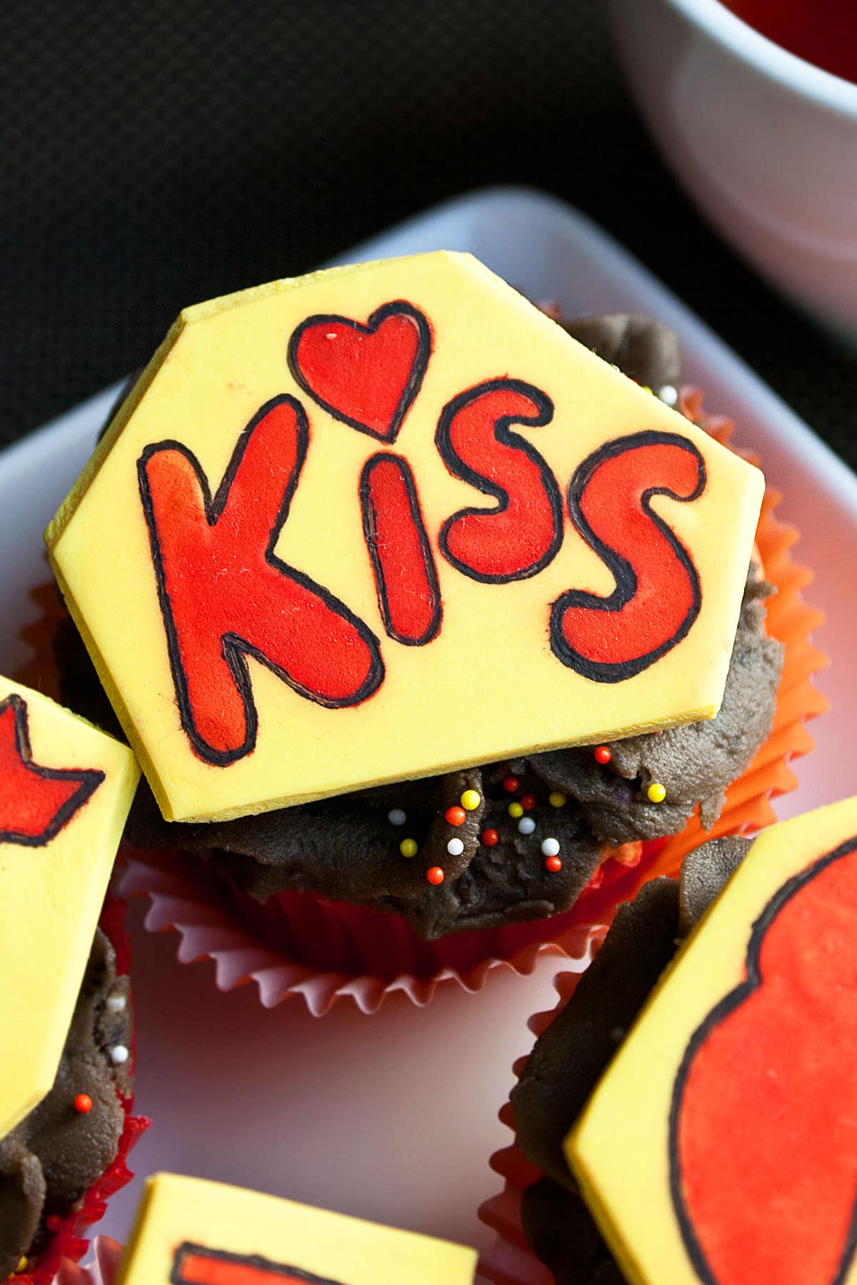 Kiss Cupcakes Decorated With Fondant and Stencils on White Dish
