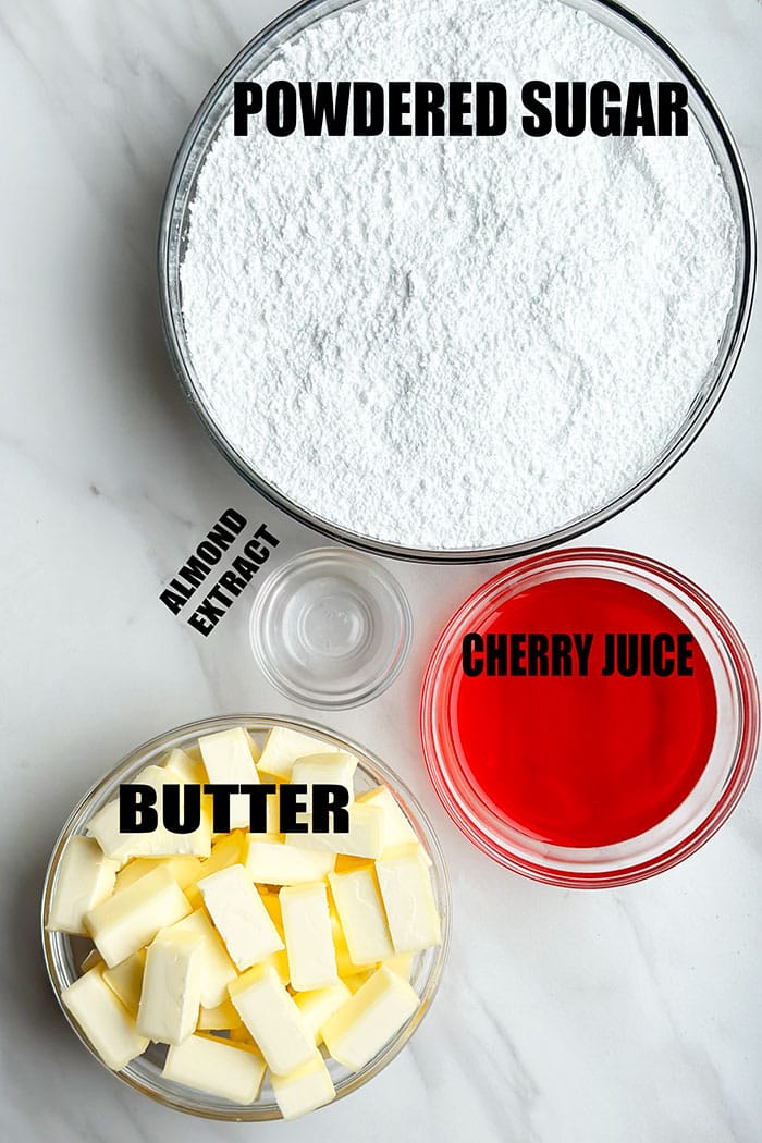 Ingredients For Cherry Icing in Glass Bowls on Marble Background