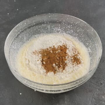 Dry ingredients added to wet mixture in glass bowl. 