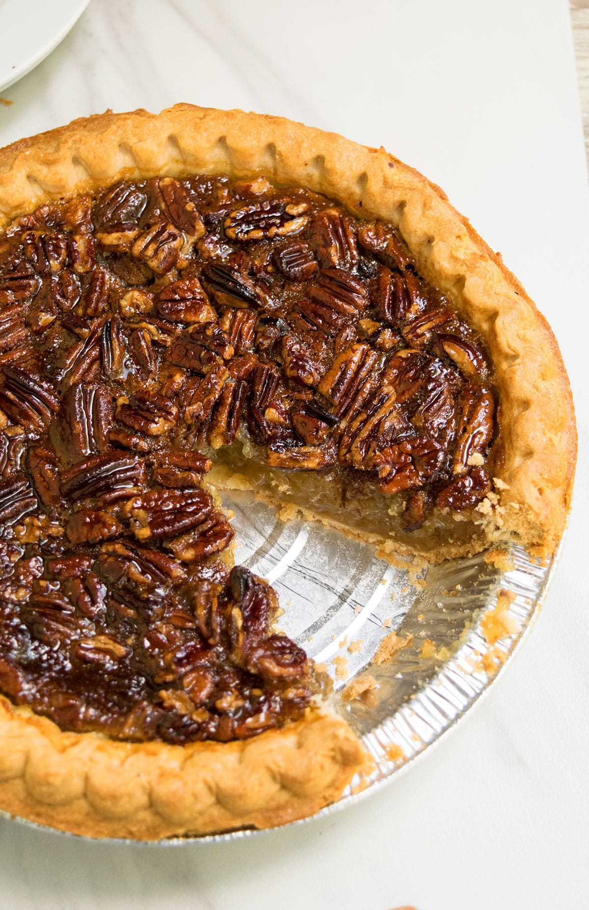 Easy Pecan Pie With One Slice Removed on White Background