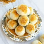 Easy White Chocolate Pumpkin Truffles in Dish With Cookie Crumbs.