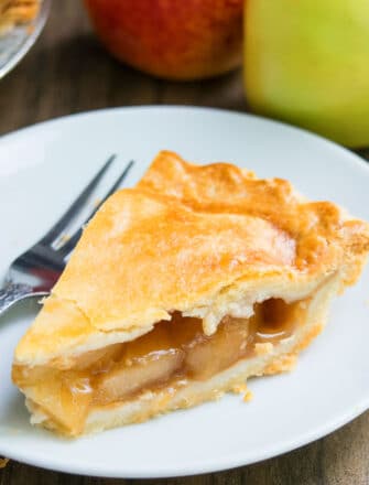 Slice of Easy Homemade Apple Pie on White Dish With Fork.