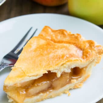 Slice of Easy Homemade Apple Pie on White Dish With Fork.