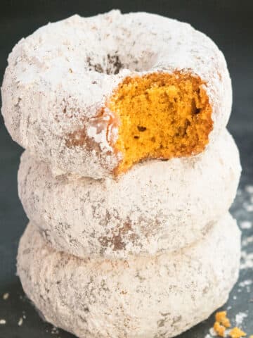 Stack of Easy Baked Pumpkin Donuts With Cake Mix on Black Dish