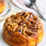 Easy Upside Down Caramel Pecan Sticky Buns on White Dish.