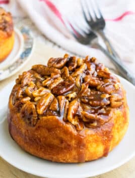 Easy Upside Down Caramel Pecan Sticky Buns on White Dish.