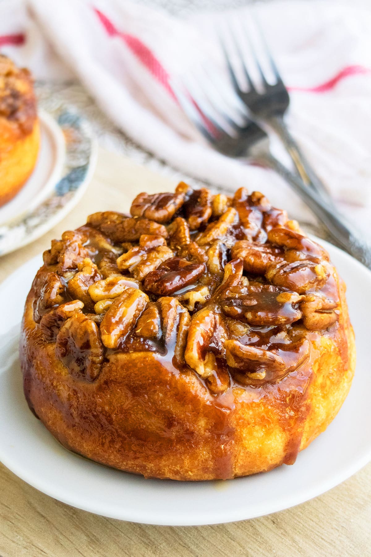 Easy Upside Down Pecan Sticky Buns on White Dish.