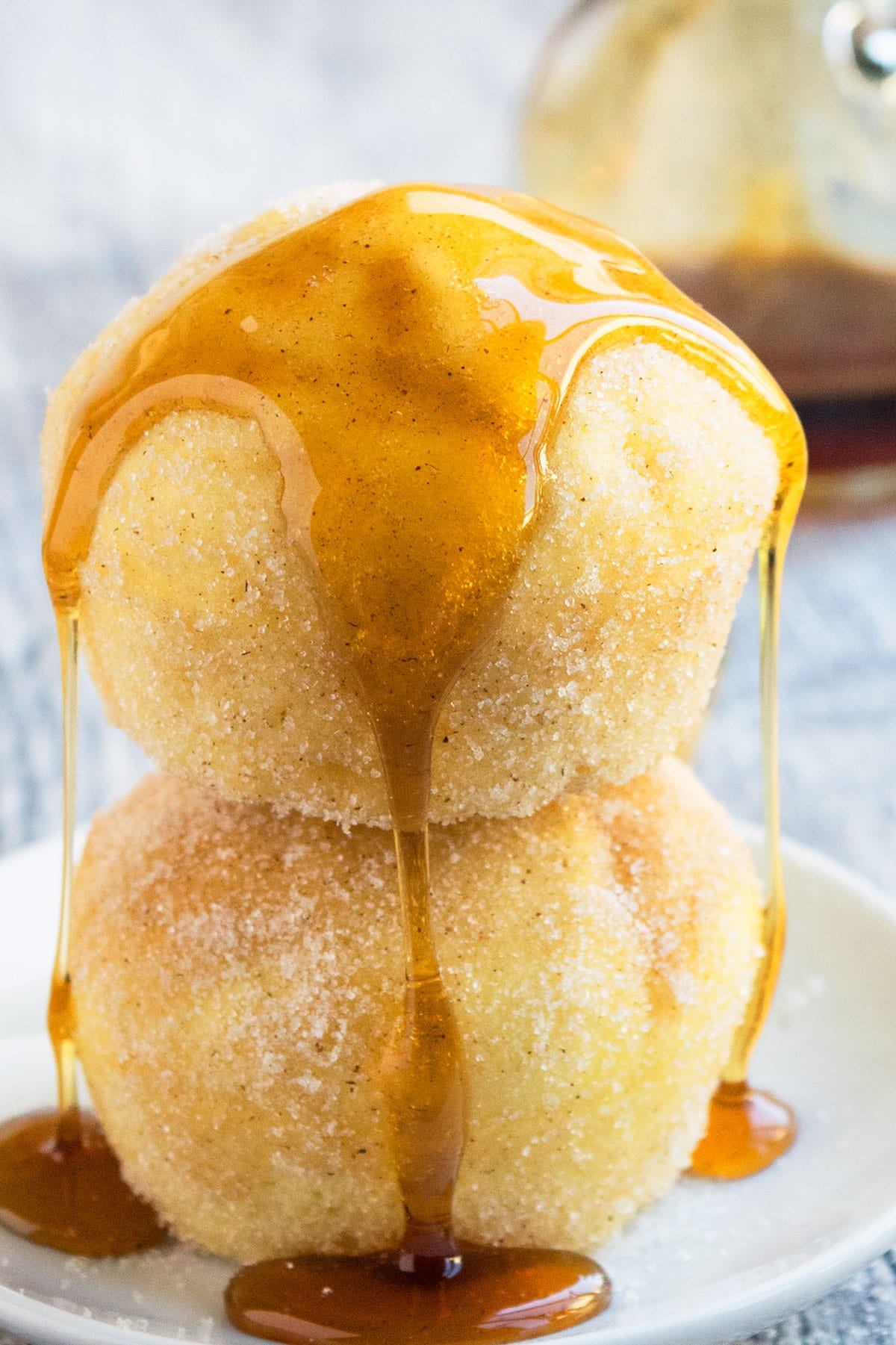 Maple Syrup Dripping on Stack of Muffins on White Dish. 