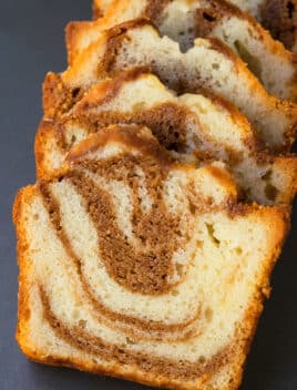Slice of Easy Cinnamon Roll Cake With Cake Mix on Gray Background.