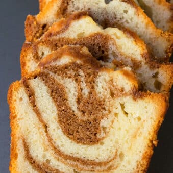 Slice of Easy Cinnamon Roll Cake With Cake Mix on Gray Background.