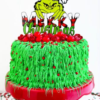 Easy Grinch Cake For Christmas on Red and White Cake Stand.