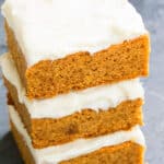 Stack of Easy Pumpkin Bars With Cream Cheese Frosting on Rustic Gray Background