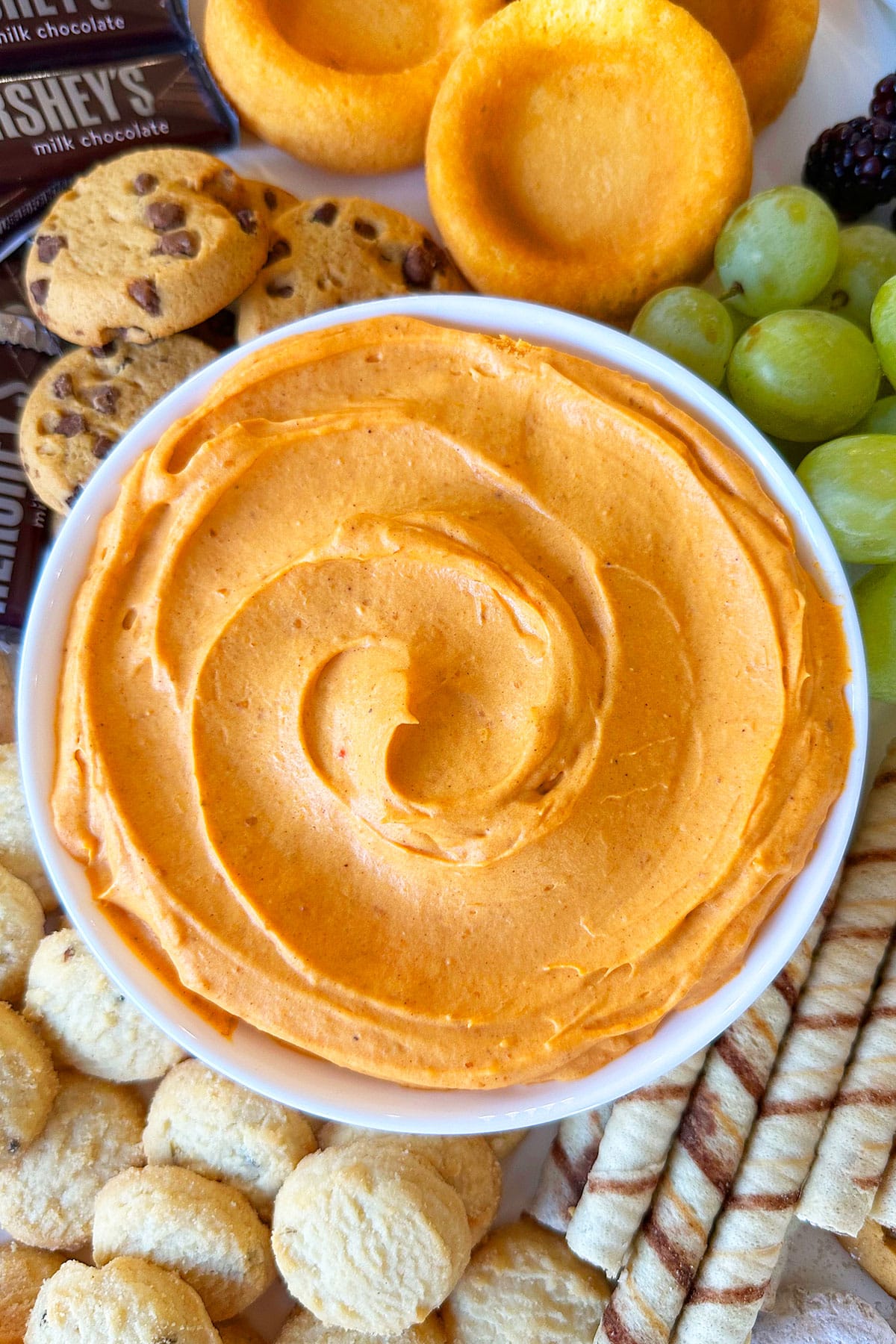 Easy Pumpkin Dip in White Bowl on Tray With Cookies. 