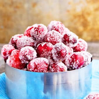 Easy Sugared Cranberries in Metallic Bowl on Blue Cloth.