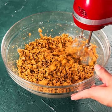 Ingredients being mixed together with a hand held mixer. 