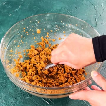 Mixture being scooped with a small spoon. 