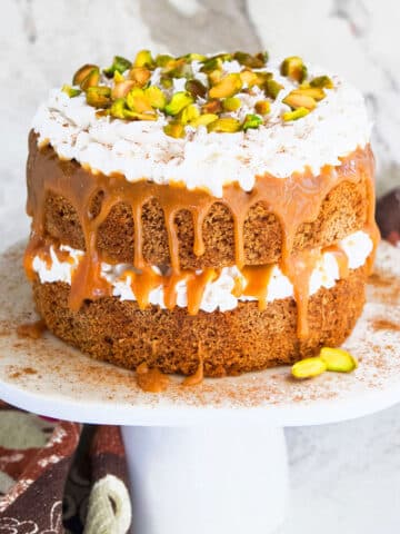 Easy Spice Cake (Chai Cake) on White Cake Stand and Marble Background.