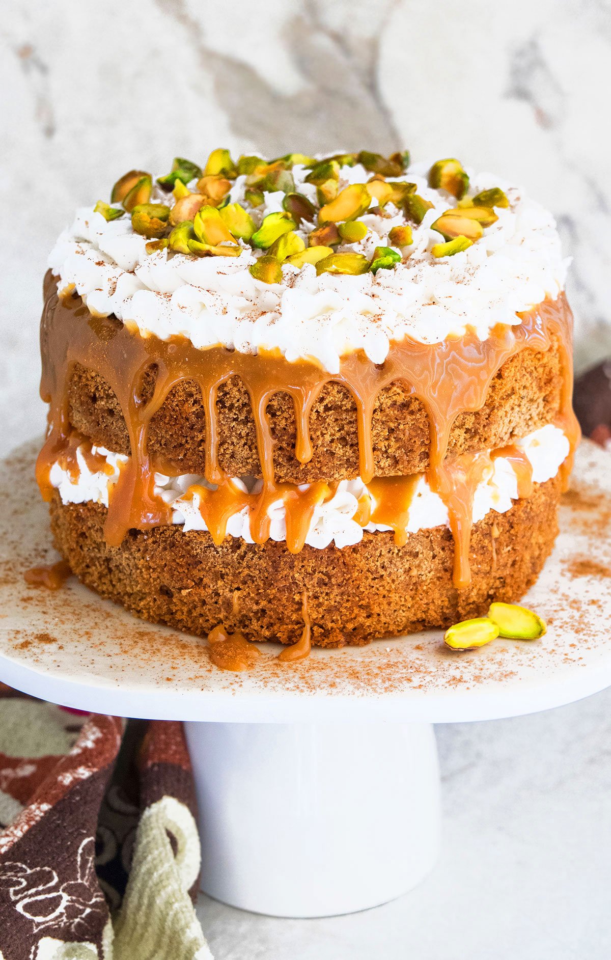 Easy Spice Cake (Chai Cake) on White Cake Stand and Marble Background. 
